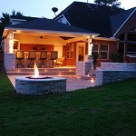 This fire pit by Outdoor Homescapes of Houston helps extend outdoor entertaining into the night with its warmth and glow near the covered patio with an outdoor kitchen, outdoor bar and grill area, retaining walls, stamped concrete hardscape and an outdoor media room. More at www.outdoorhomescapes.com