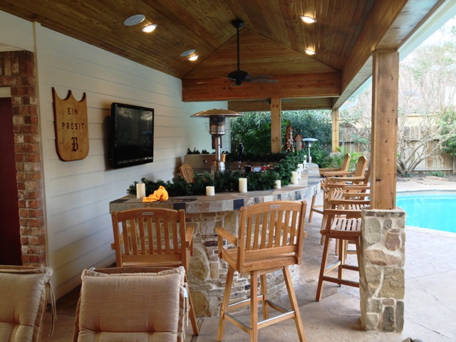 Outdoor decorating ideas include changing it up for each season, as these homeowners did with evergreen boughs and candles in winter, says Lisha Maxey, senior designer with Outdoor Homescapes of Houston. More outdoor decor ideas for your patio or outdoor living space by this Houston outdoor living space designer at www.outdoorhomescapes.com