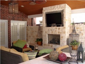 Outdoor living space with fireplace and TV area in Outdoor Homescapes of Houston's vote contest sponsored by Wishpond. Details under "Blog" at www.outdoorhomescapes.com