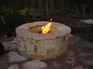 This fire pit is one of the many designed and built by Outdoor Homescapes of Houston, an outdoor living space designer specializing in outdoor kitchens, patios and covered patios, fire pits, water features, stamped or designer concrete, pergolas, arbors, mosquito and lighting systems, outdoor media systems, bar and grill areas and more. More at www.outdoorhomescapes.com