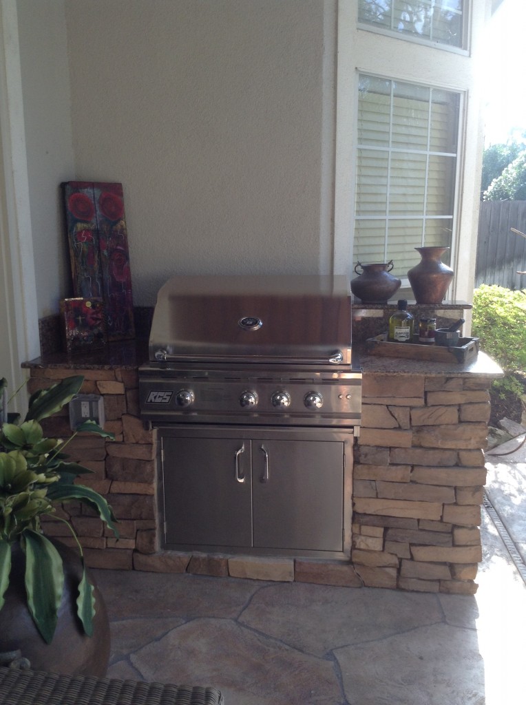 Outdoor furniture transformed this covered patio with an outdoor kitchen island in Houston. More on this outdoor living space design at www.outdoorhomescapes.com