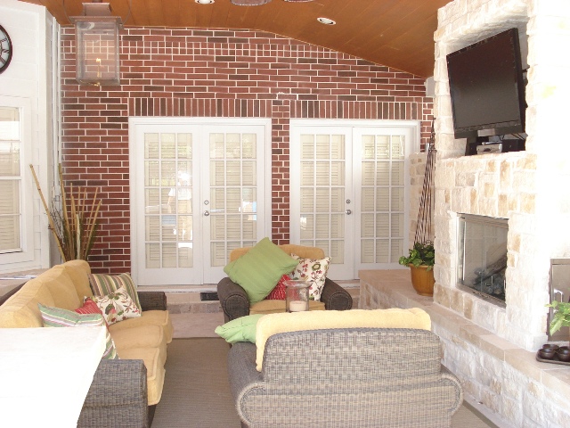 Houston covered patios like this one designed and built by Outdoor Homescapes of Houston offer shade and heat protection for outdoor TVs used during football season. More at www.outdoorhomescapes.com