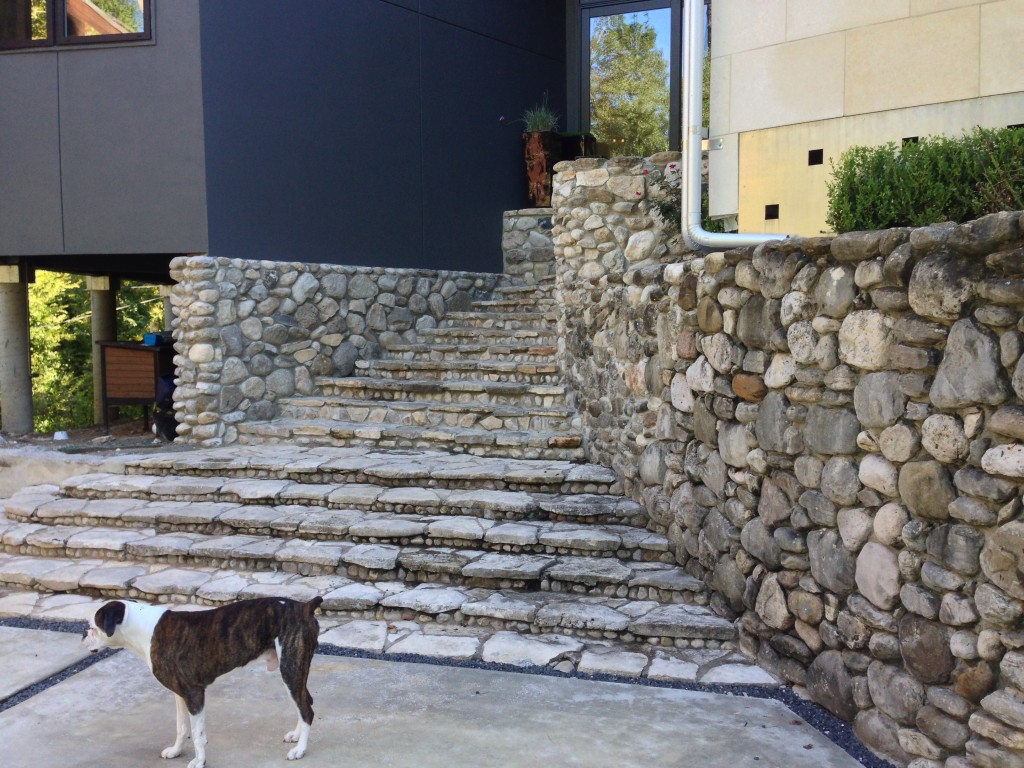 A modern outdoor kitchen by Outdoor Homescapes of Houston was designed for this ultra modern Houston home. It included a pizza oven faced with stone matching that found on these exterior walls. More outdoor living spaces by this Houston outdoor designer at www.outdoorhomescapes.com