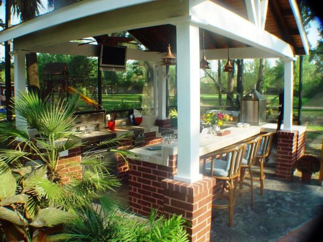 This Houston outdoor kitchen design has become a huge hub for watching football on TV outdoors during football season. This tropical themed cabana by Outdoor Homescapes of Houston features a flat-screen mounted to a cross-beam with an outdoor kitchen, bar and grill.  More Houston outdoor kitchens by Outdoor Homescapes at www.outdoorhomescapes.com