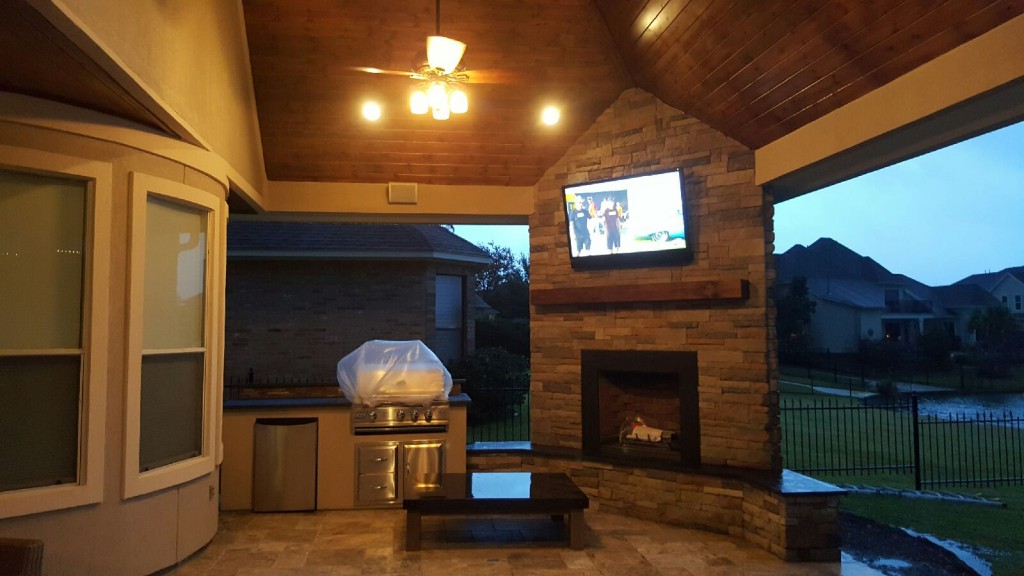 This Houston patio addition by Outdoor Homescapes of Houston features an outdoor kitchen, corner fireplace with rustic ledgestone and silver travertine flooring. It also features Restoration Hardware furnishings and accents. More at www.outdoohomescapes.com/blog