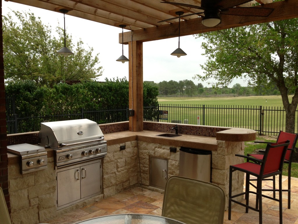 This Houston patio addition by Outdoor Homescapes of Houston features an outdoor kitchen faced in  Austin limestone dry-stacked in a castle pattern. The components are an RCS 30-inch grill, double burner and outdoor refrigerator. The flooring is Fantastico travertine and the countertop is English walnut travertine. More at www.outdoorhomescapes.com/blog