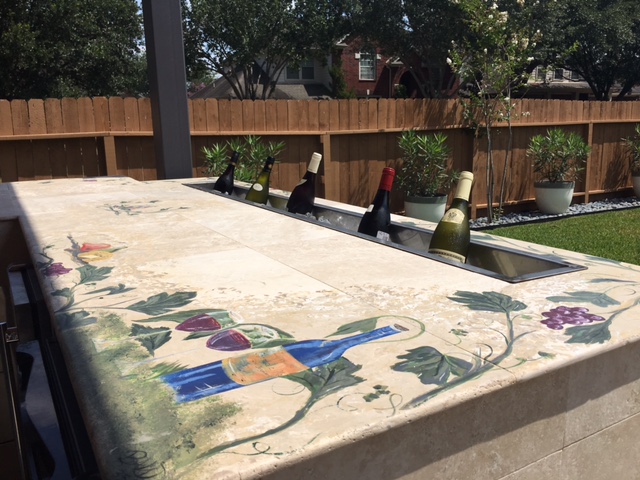 This unique Houston covered patio addition includes painted Tuscan details on a concrete counter, plus a "wine trough." More details at www.outdoorhomescapes.com/blog