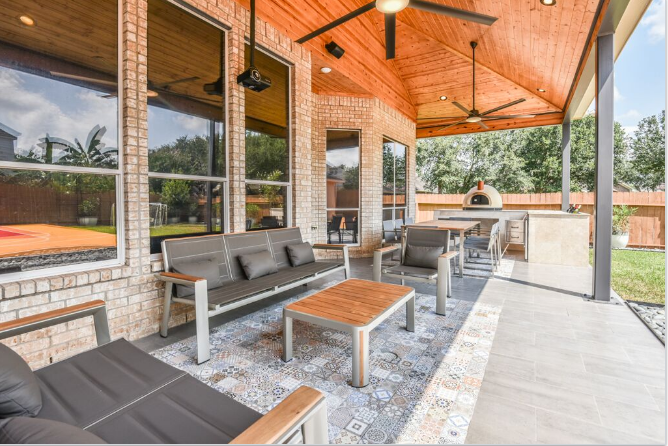 This unique Houston patio features a colorful, detailed-tile "area rug," a "wine trough", minimalist furniture and a basketball court! More info at www.outdoorhomescapes.com/blog